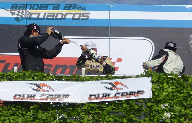 Fernando Moni empapa con champán a Agustín Herrera, los ganadores en la Clase 3.